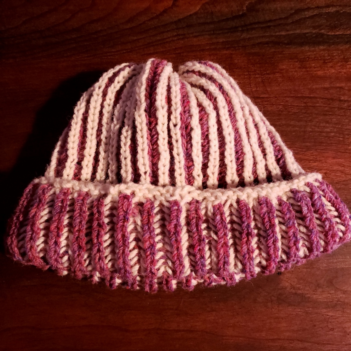 A hat knitted in brioche stitch in white and red.